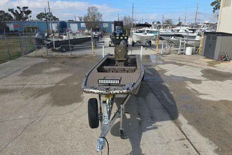 Slide: The Image of 2026 Pro-Drive 2060 boat on trailer in a marina setting. - 2