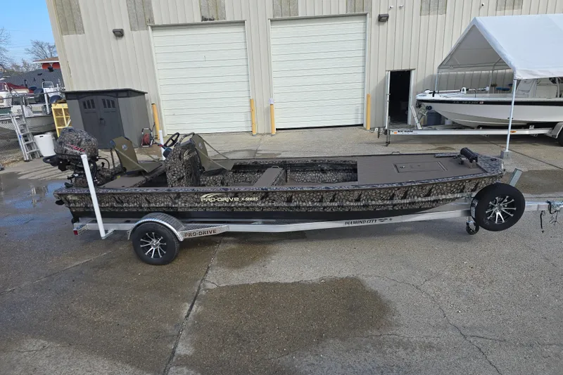 Slide: The Image of 2026 Pro-Drive 2060 boat on trailer, parked outside a warehouse. - 4