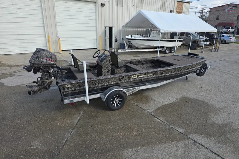 Slide: The Image of 2026 Pro-Drive 2060 boat on trailer, parked outside industrial building. - 5