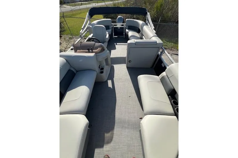 Slide: The Image of 2024 Starcraft LX 20 R pontoon boat with spacious seating and modern design. - 2