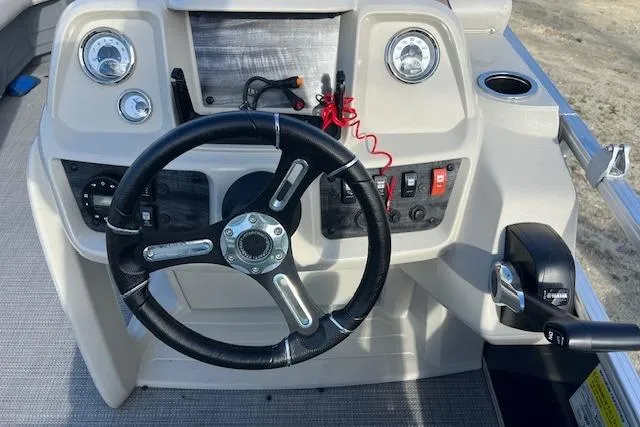 Slide: The Image of 2024 Starcraft LX 20 R boat dashboard with steering wheel and control panel. - 4