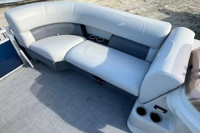 Slide: The Image of 2024 Starcraft LX 20 R boat interior with gray seating and cup holders. - 7