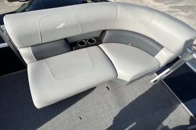 Slide: The Image of 2024 Starcraft LX 20 R boat interior with gray seating and cup holders. - 8