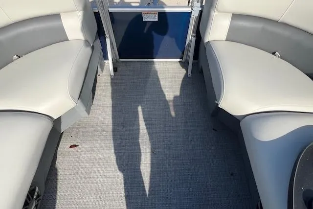Slide: The Image of 2024 Starcraft LX 20 R boat interior with gray seating and flooring. - 9