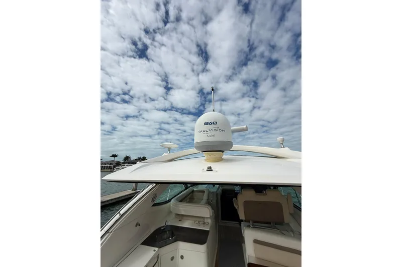Slide: The Image of 2014 Sea Ray 470 Sundancer yacht with satellite dome under cloudy sky. - 13