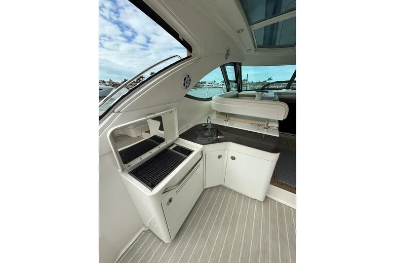 Slide: The Image of 2014 Sea Ray 470 Sundancer yacht interior with kitchenette and sleek design. - 18