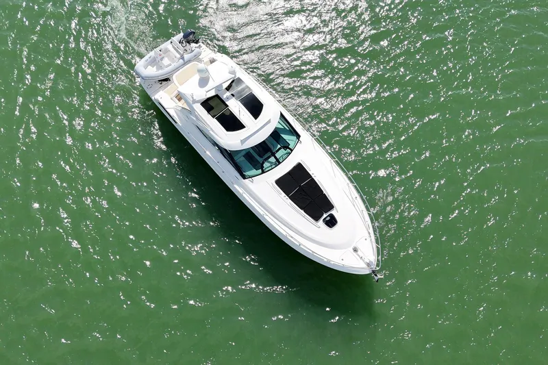 Slide: The Image of Aerial view of 2014 Sea Ray 470 Sundancer yacht on green water. - 2