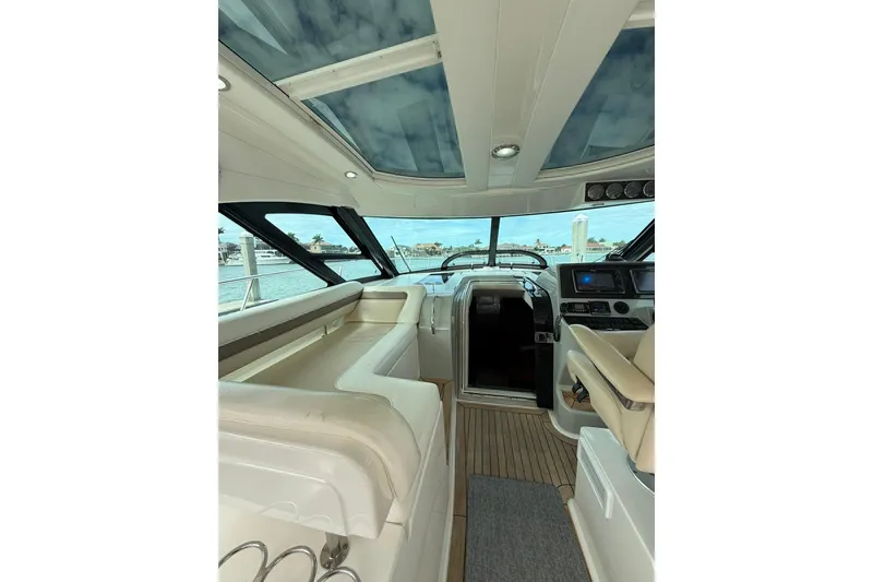 Slide: The Image of Interior of 2014 Sea Ray 470 Sundancer yacht with luxurious seating and modern helm. - 24