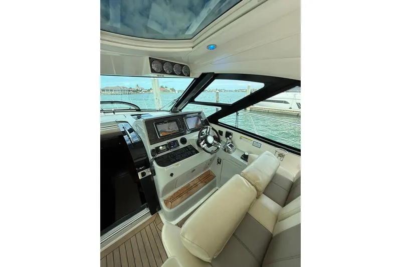 Slide: The Image of Interior view of 2014 Sea Ray 470 Sundancer yacht cockpit with modern controls. - 26