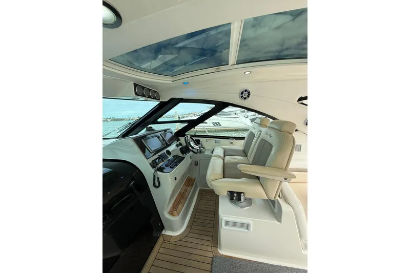 Slide: The Image of Luxurious helm of 2014 Sea Ray 470 Sundancer yacht with leather seats and modern controls. - 28
