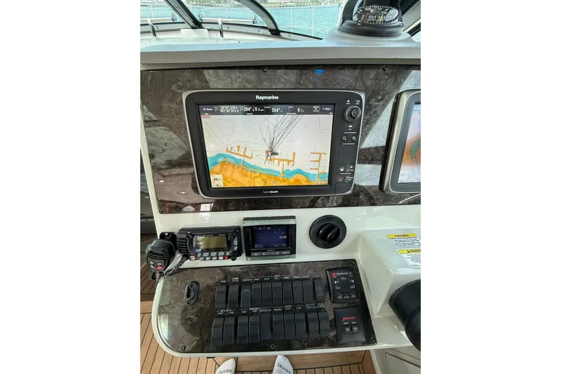 Slide: The Image of 2014 Sea Ray 470 Sundancer helm with navigation display and control panel. - 31