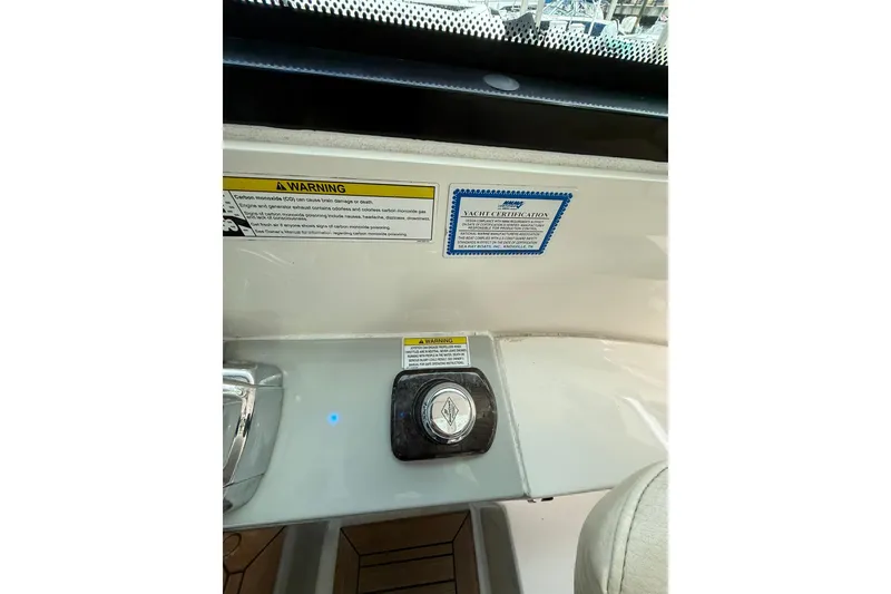 Slide: The Image of 2014 Sea Ray 470 Sundancer dashboard with warning labels and yacht certification. - 34