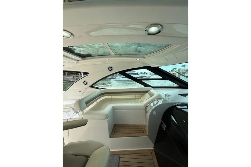 Slide: The Image of Interior view of 2014 Sea Ray 470 Sundancer yacht with luxurious seating and panoramic windows. - 37