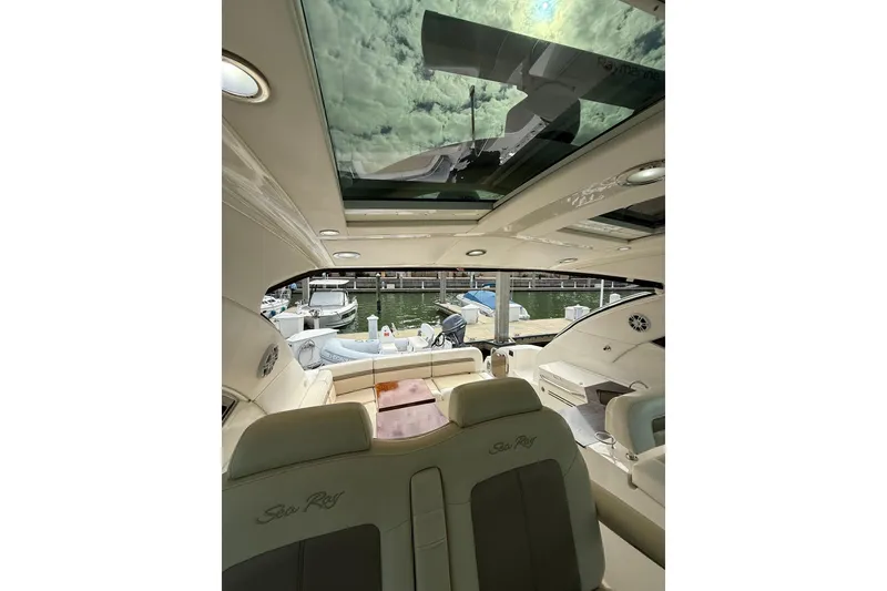 Slide: The Image of Luxurious interior of 2014 Sea Ray 470 Sundancer yacht with skylight and dock view. - 38