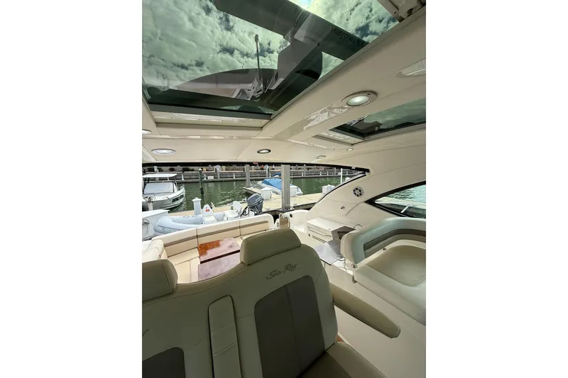 Slide: The Image of Interior view of 2014 Sea Ray 470 Sundancer yacht with open sunroof and luxurious seating. - 39