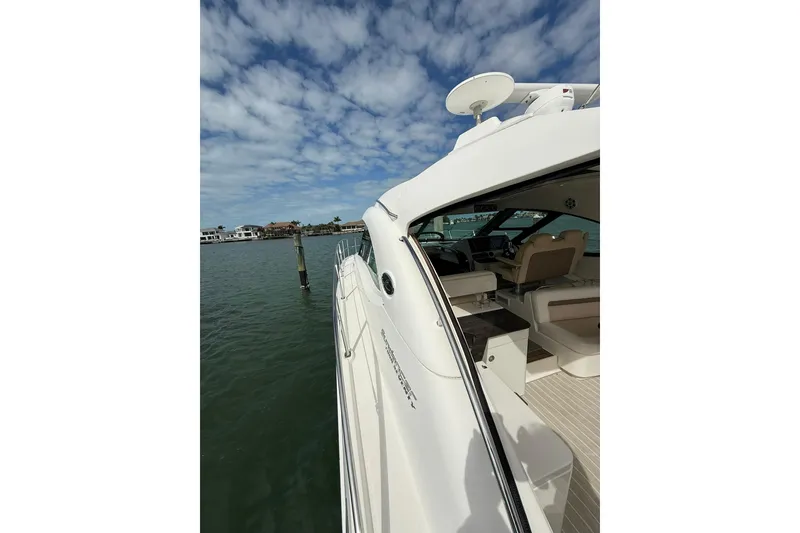 Slide: The Image of 2014 Sea Ray 470 Sundancer yacht docked, showcasing sleek design and luxurious interior. - 41