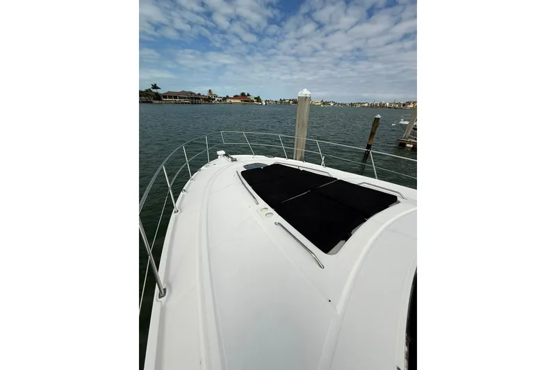 Slide: The Image of 2014 Sea Ray 470 Sundancer yacht on calm water with cloudy sky. - 43