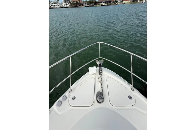 Slide: The Image of Bow view of 2014 Sea Ray 470 Sundancer yacht on calm water. - 44
