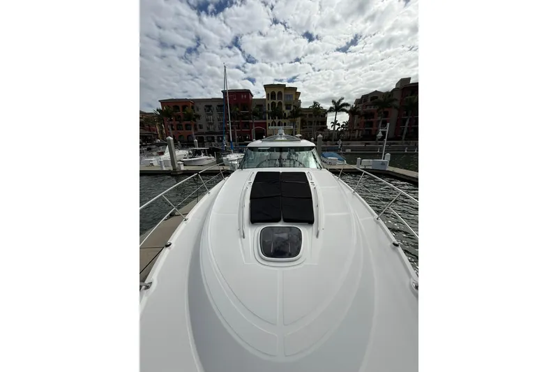 Slide: The Image of 2014 Sea Ray 470 Sundancer yacht docked at marina under cloudy sky. - 46