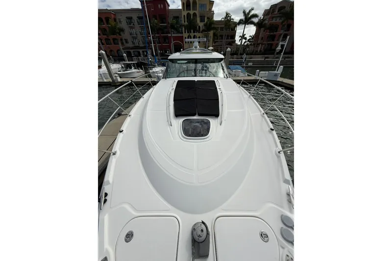 Slide: The Image of 2014 Sea Ray 470 Sundancer yacht docked at marina, showcasing sleek design and spacious deck. - 47