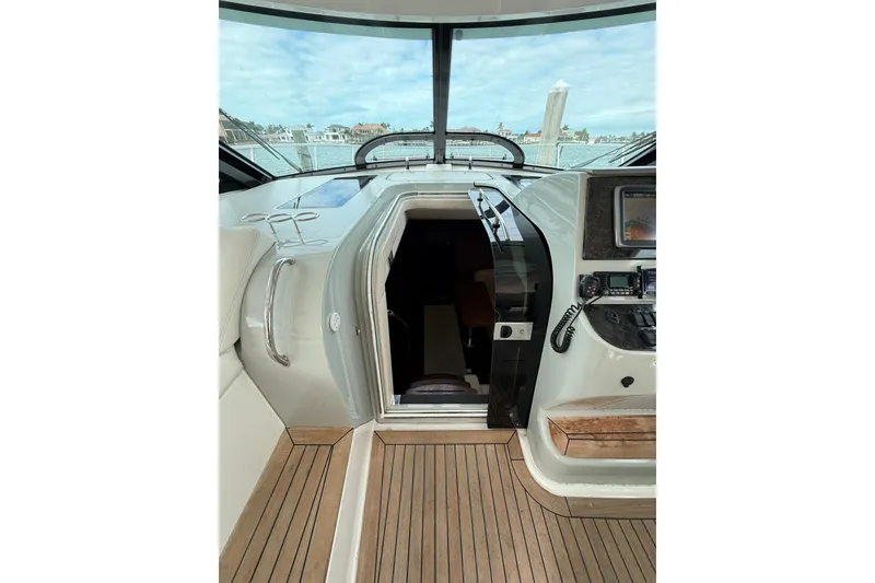 Slide: The Image of 2014 Sea Ray 470 Sundancer yacht interior with wooden flooring and navigation equipment. - 49