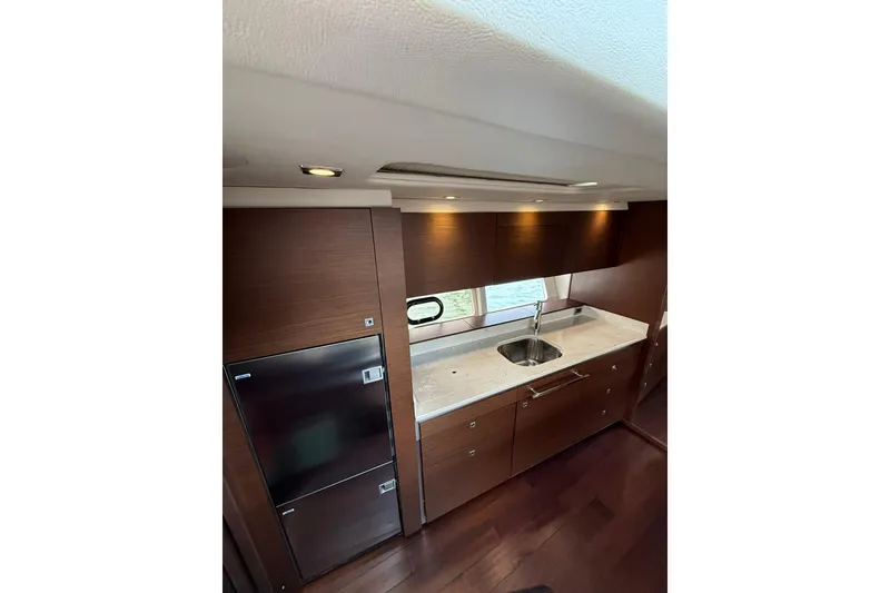 Slide: The Image of Luxurious kitchen interior of 2014 Sea Ray 470 Sundancer yacht with modern amenities. - 51