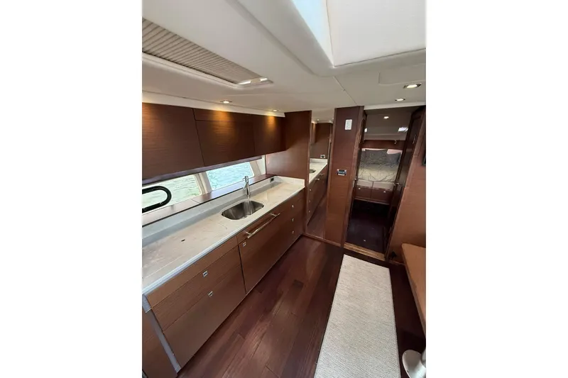 Slide: The Image of Luxurious interior of 2014 Sea Ray 470 Sundancer yacht with modern kitchen design. - 54