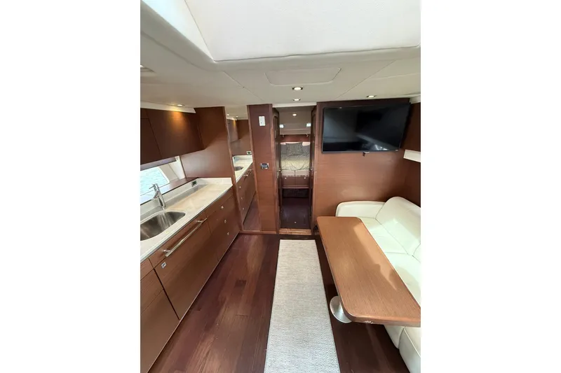 Slide: The Image of Interior of 2014 Sea Ray 470 Sundancer yacht with modern kitchen and seating area. - 55