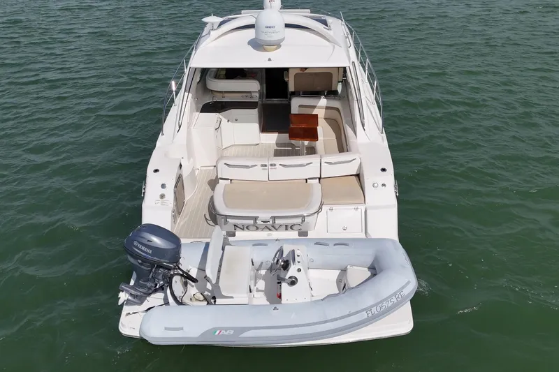 Slide: The Image of 2014 Sea Ray 470 Sundancer yacht with inflatable boat on water. - 6