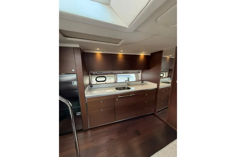 Slide: The Image of Luxurious interior of 2014 Sea Ray 470 Sundancer yacht with modern kitchen amenities. - 60