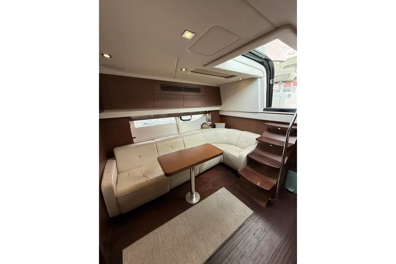 Slide: The Image of Luxurious interior of 2014 Sea Ray 470 Sundancer yacht with elegant seating and wooden accents. - 64