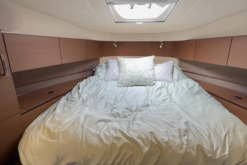 Slide: The Image of Luxurious bedroom interior of 2014 Sea Ray 470 Sundancer yacht with cozy bedding. - 67