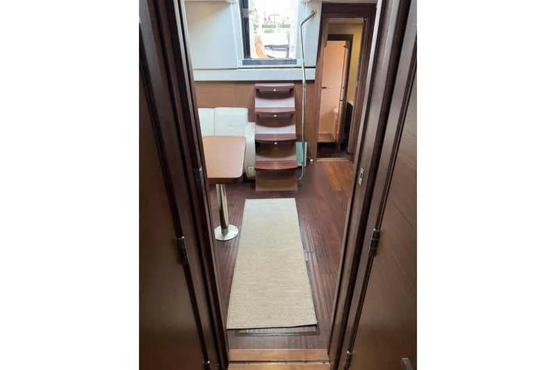Slide: The Image of Interior of 2014 Sea Ray 470 Sundancer yacht, featuring elegant wood flooring and modern furnishings. - 73