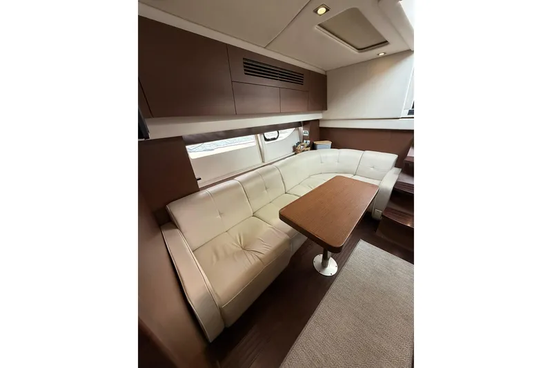Slide: The Image of Luxurious interior of 2014 Sea Ray 470 Sundancer yacht with plush seating and wooden table. - 74