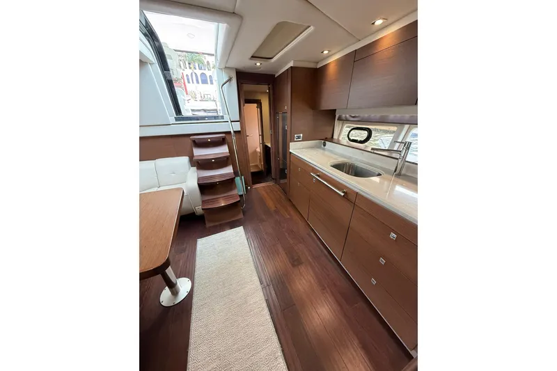 Slide: The Image of Luxurious interior of 2014 Sea Ray 470 Sundancer yacht with modern kitchen and seating area. - 76
