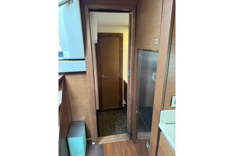 Slide: The Image of Interior view of 2014 Sea Ray 470 Sundancer yacht, featuring wooden cabinetry and modern design. - 78