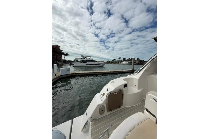 Slide: The Image of 2014 Sea Ray 470 Sundancer docked at marina under cloudy sky. - 8
