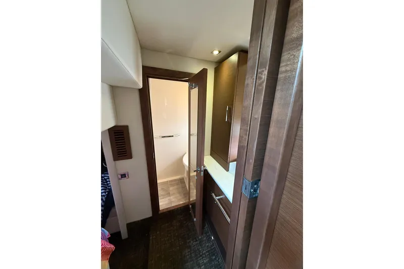 Slide: The Image of Interior view of 2014 Sea Ray 470 Sundancer yacht bathroom with wooden cabinetry. - 82