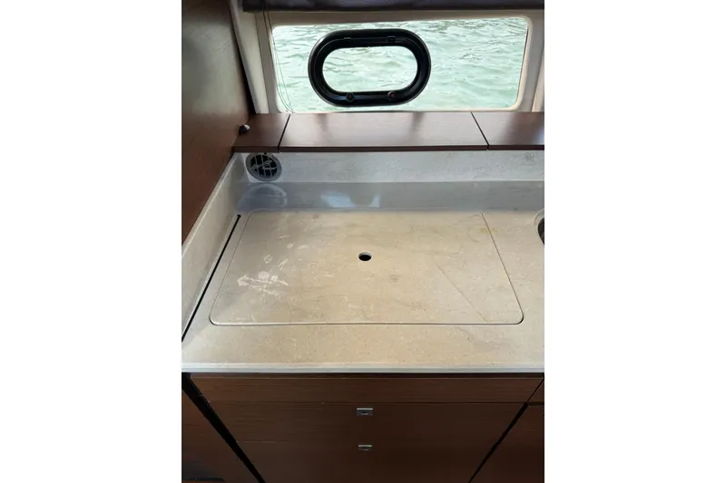 Slide: The Image of 2014 Sea Ray 470 Sundancer yacht interior kitchen counter with window view. - 86