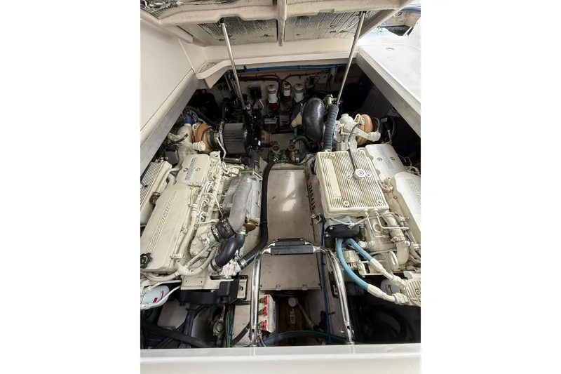 Slide: The Image of Engine compartment of a 2014 Sea Ray 470 Sundancer, showcasing dual engines and mechanical components. - 91