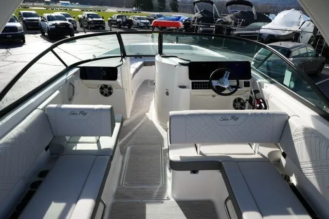 Slide: The Image of 2025 Sea Ray SDX 270 boat interior with sleek seating and modern dashboard. - 13
