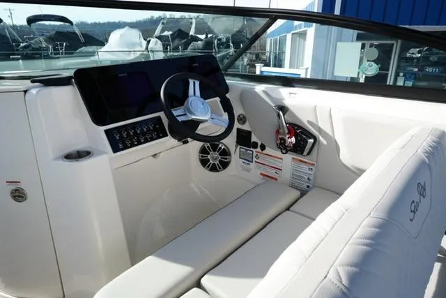 Slide: The Image of 2025 Sea Ray SDX 270 boat interior with modern dashboard and steering wheel. - 14