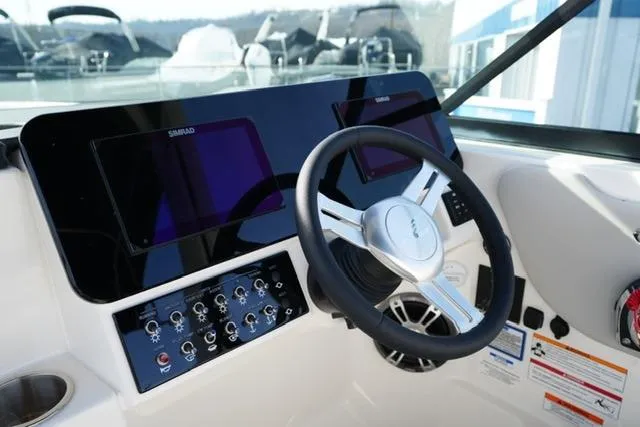 Slide: The Image of 2025 Sea Ray SDX 270 helm with modern controls and steering wheel. - 15