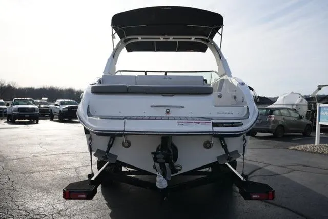 Slide: The Image of 2025 Sea Ray SDX 270 boat on trailer, rear view, parked outdoors. - 6