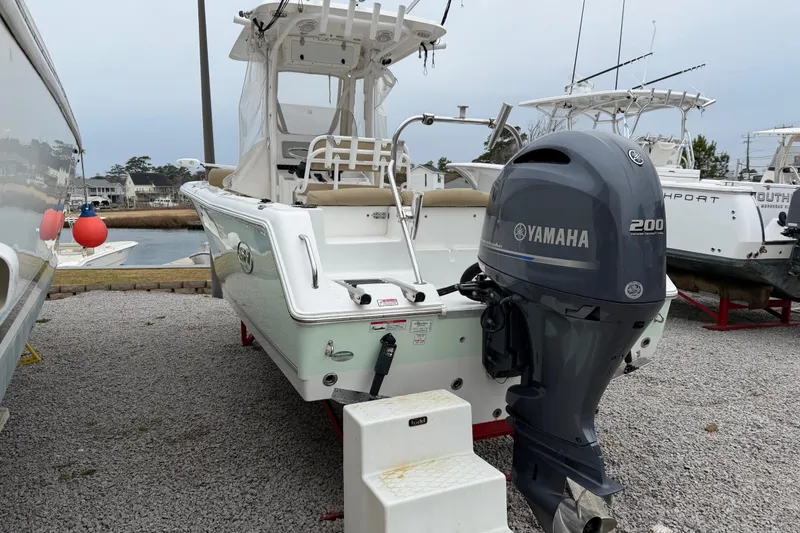 Slide: The Image of 2016 Sea Hunt Ultra 234 boat with Yamaha 200 engine, docked on gravel. - 12