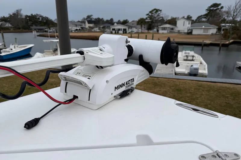 Slide: The Image of Minn Kota Terrova motor on 2016 Sea Hunt Ultra 234 boat, docked near waterfront homes. - 22