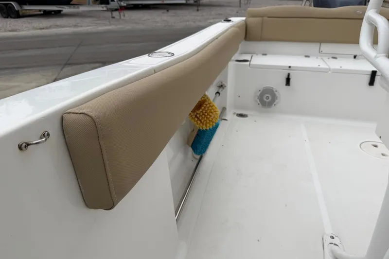 Slide: The Image of 2016 Sea Hunt Ultra 234 boat interior with beige seating and storage area. - 25