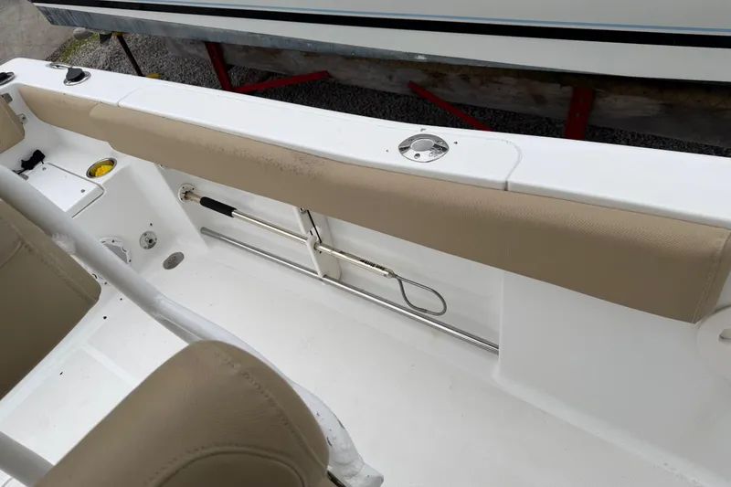 Slide: The Image of 2016 Sea Hunt Ultra 234 boat interior with beige seating and rod holder. - 26
