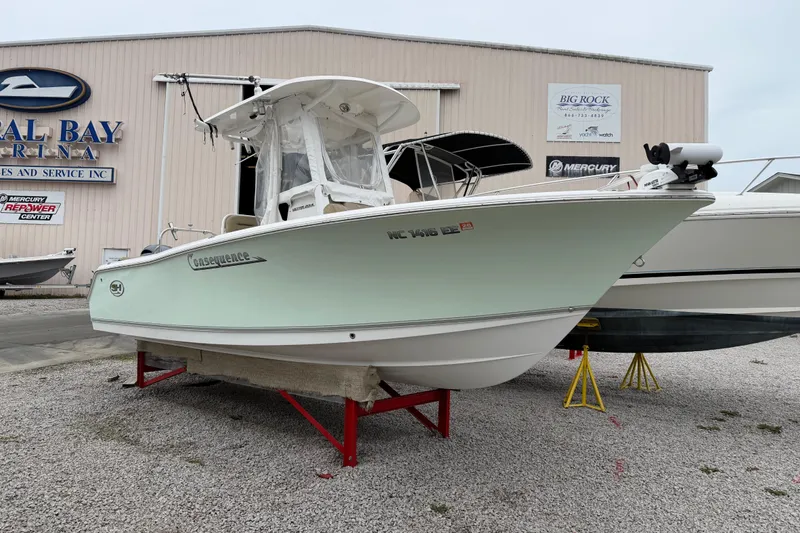 Slide: The Image of 2016 Sea Hunt Ultra 234 boat displayed at a marina, side view. - 9