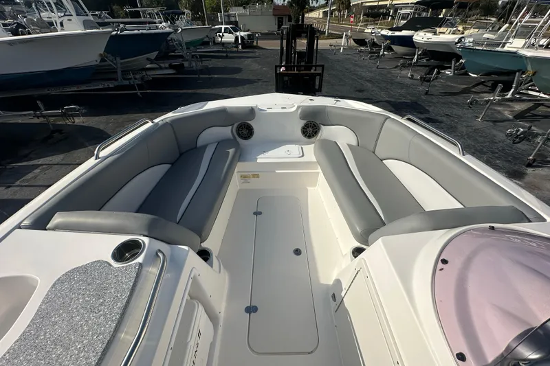 Slide: The Image of 2022 NauticStar 203 SC boat interior with gray seating and cup holders. - 13